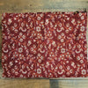A rich maroon 100 percent acrylic shawl with white and orange floral patterns and woven texture for summer evenings