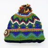 A wool bobble hat made from zealand wool with multicoloured felt bobble and green blue purple geometric pattern