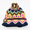 A wool bobble hat with a colourful multicoloured felt bobble and star button made from zealand wool