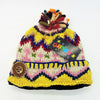 A colorful wool bobble hat with a multicoloured felt bobble and decorative button made from zealand wool