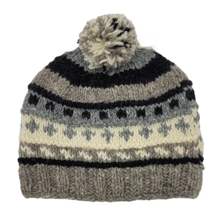 A cozy wool classic bobble hat in gray black and cream with geometric patterns and a fluffy pom-pom made from zealand wool