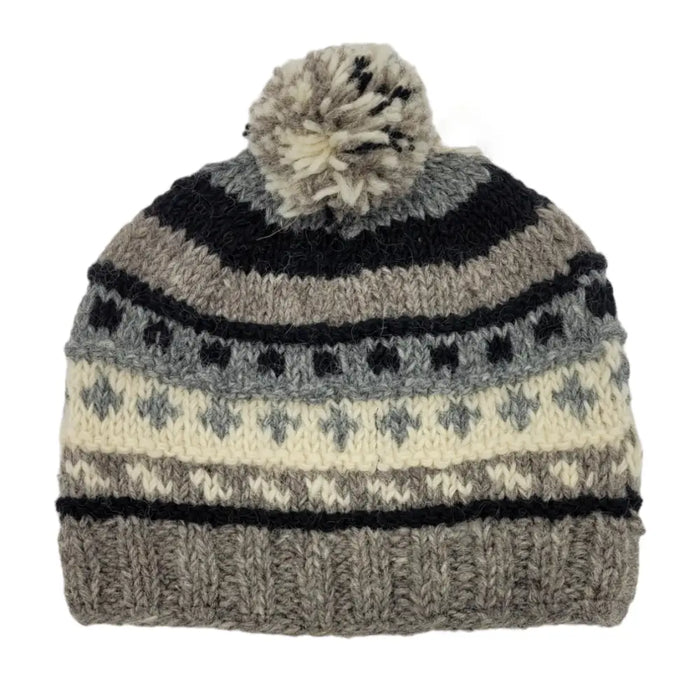 A cozy wool classic bobble hat in gray black and cream with geometric patterns and a fluffy pom-pom made from zealand wool