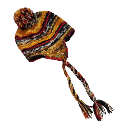 A cozy orange ear-flap hat made of fair trade zealand wool with braided ear flaps and a multicolored pom-pom