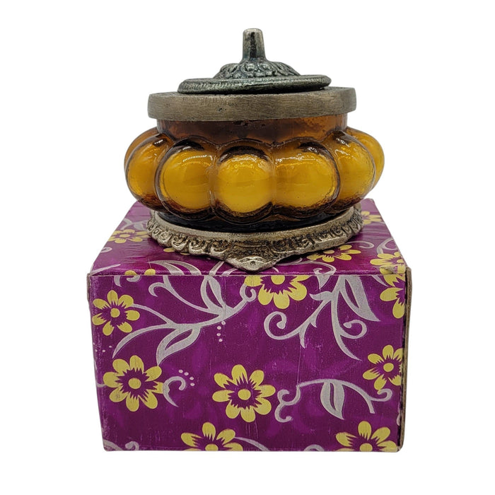 The Window, Milford Haven Precious Sandal scented soy candle in a yellow pumpkin-shaped glass jar with ornate metal lid.