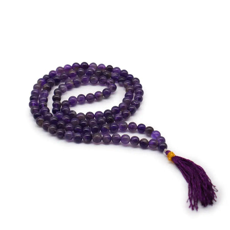 A bead mala necklace coiled with smooth amethyst beads in deep purple and light shades with a matching tassel and velvet pouch