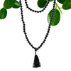 Black agate mala necklace with 108 beads and matching tassel pendant shown with a black velvet pouch