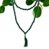 A deep green jade bead mala necklace with 108 beads and a matching tassel pendant shown with a velvet pouch