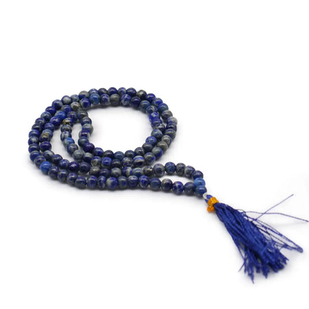 A deep blue lapis lazuli bead mala necklace with 108 beads, an orange accent bead, and a matching tassel in a velvet pouch