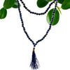 A deep blue lapis bead mala necklace with 108 beads and a matching tassel pendant shown with a velvet pouch