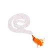 108 bead mala necklace with clear rock crystal beads and an orange tassel shown with a velvet pouch background