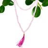 Delicate rose quartz bead mala necklace with 108 beads and a vibrant magenta tassel shown with velvet pouch