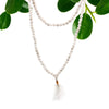 White quartz bead mala necklace with delicate white beads and soft tassel pendant shown with velvet pouch