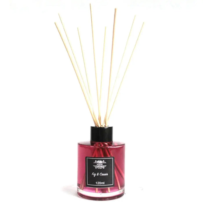 A glass bottle reed diffuser with pink fig and cassis liquid and light reed sticks in a black cap and label
