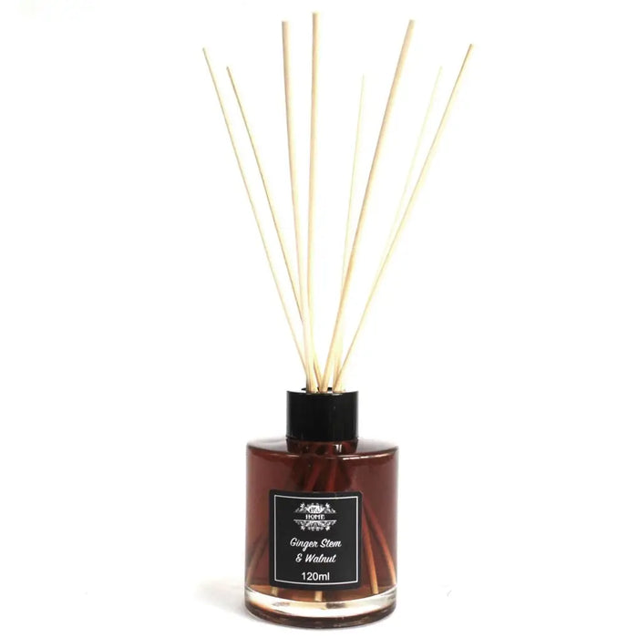 A sleek amber glass bottle reed diffuser with a black cap and light beige wooden reeds for ginger stem scent