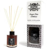 A sleek black glass reed diffuser bottle with matte finish, amber ginger stem oil, and natural wood reeds