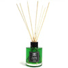 Green glass tea reed diffuser with black cap and label and light wood reeds for a white tea reed oil lasts 120ml