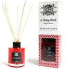 Red glass reed diffuser with black cap and label in cherry woods scent in a 120ml glass bottle