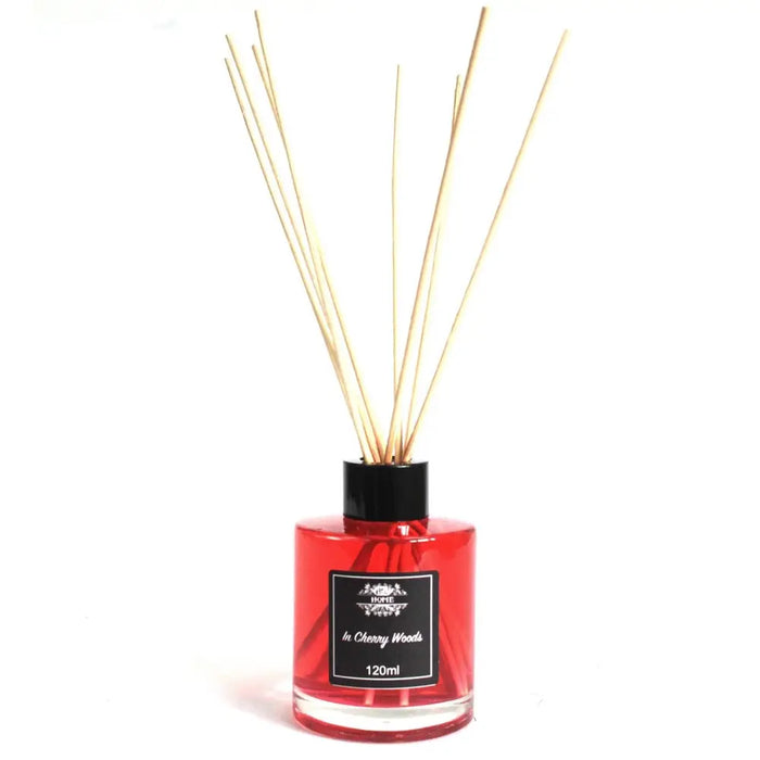 Red glass bottle reed diffuser with black cap and beige reeds in cherry woods scent and 120ml size
