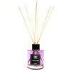 A clear glass bottle reed diffuser filled with purple lavender fields liquid and light wooden reeds topped with black cap