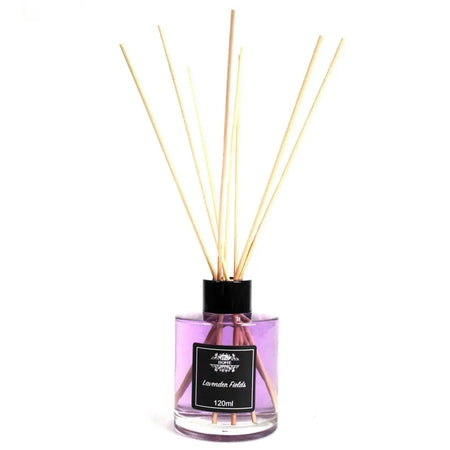 A clear glass bottle reed diffuser filled with purple lavender fields liquid and light wooden reeds topped with black cap