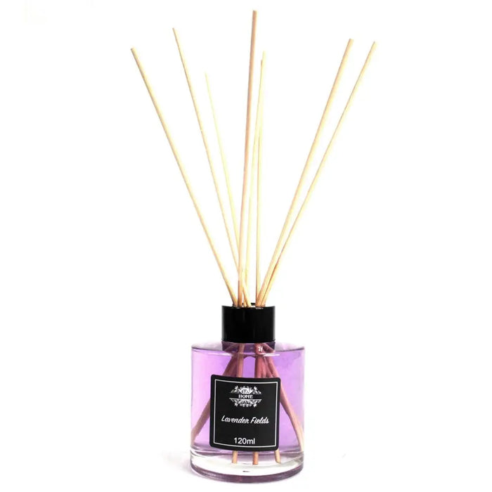 A clear glass bottle reed diffuser filled with purple lavender fields liquid and light wooden reeds topped with black cap