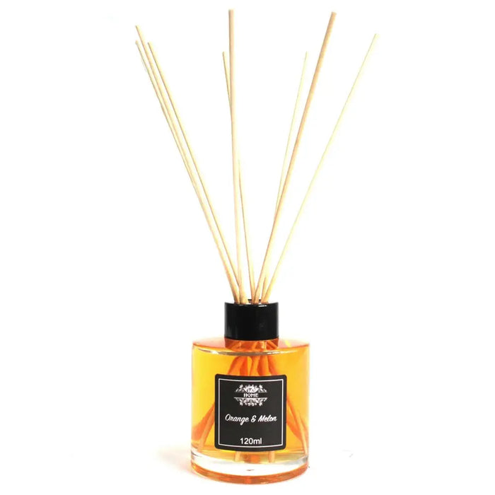 A glass bottle reed diffuser with amber oil and wooden reeds labeled orange and melon 120ml with oil that lasts