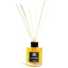 A clear glass bottle reed diffuser filled with golden vanilla plantation liquid and light wooden reeds