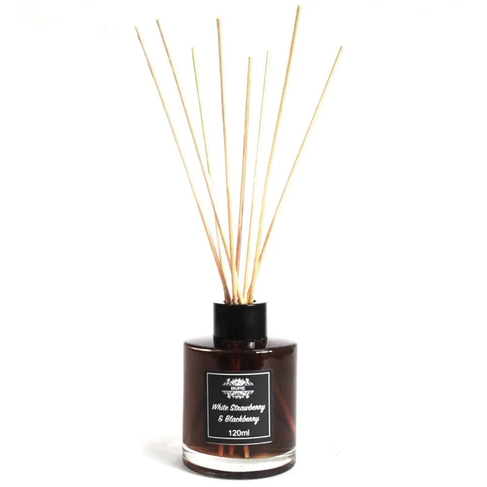 A dark amber glass bottle reed diffuser with black cap and light wooden reeds for white strawberry scent