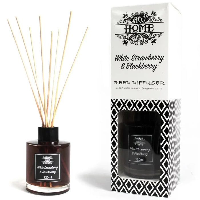 White strawberry and blackberry reed diffuser in a clear glass bottle with black cap and natural wooden reeds