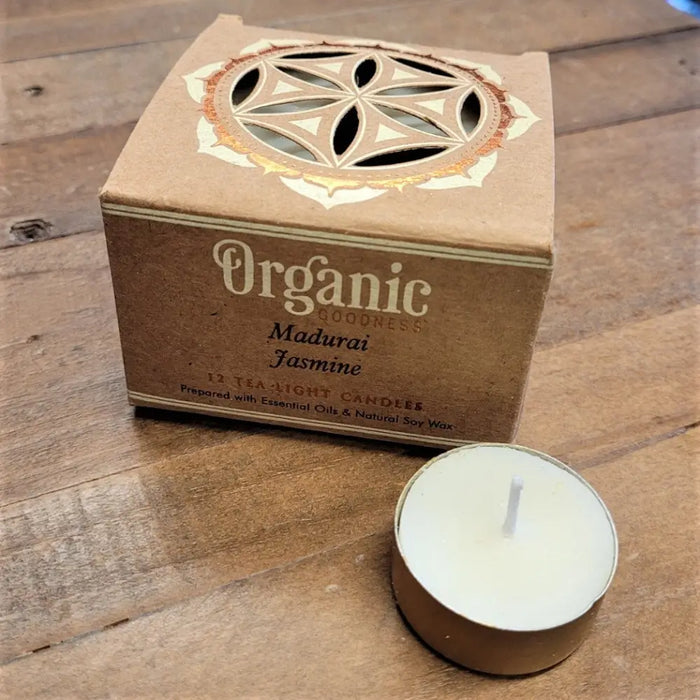 A white tea light candle in a gold tin with a brown box labeled organic goodness madurai jasmine from india organic scented tealights six fragrances
