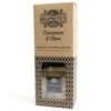 200ml cinnamon and clove reed diffuser in clear glass bottle with black label, clove essential oil, and rattan sticks