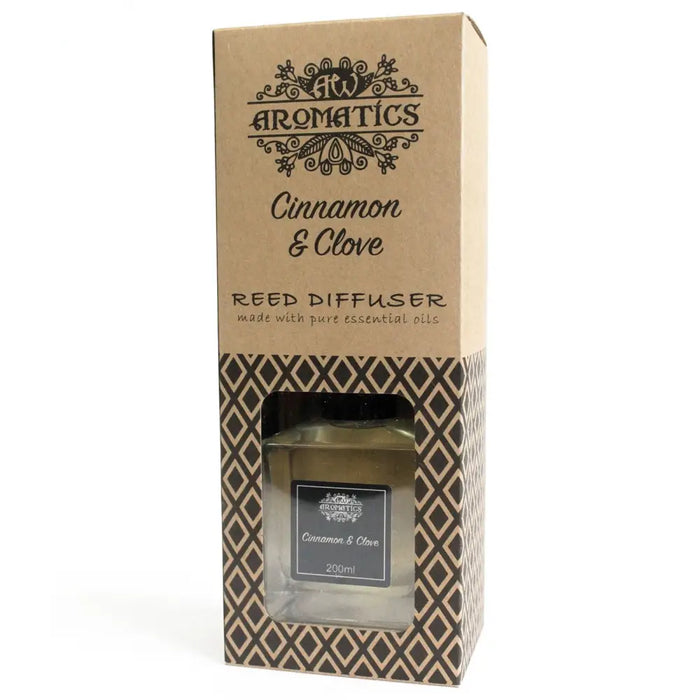 200ml cinnamon and clove reed diffuser in clear glass bottle with black label, clove essential oil, and rattan sticks
