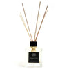 Clear glass reed diffuser with black cap, light brown rattan sticks, 200ml cinnamon and clove essential oil scent