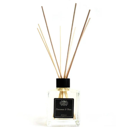 Clear glass reed diffuser with black cap, light brown rattan sticks, 200ml cinnamon and clove essential oil scent