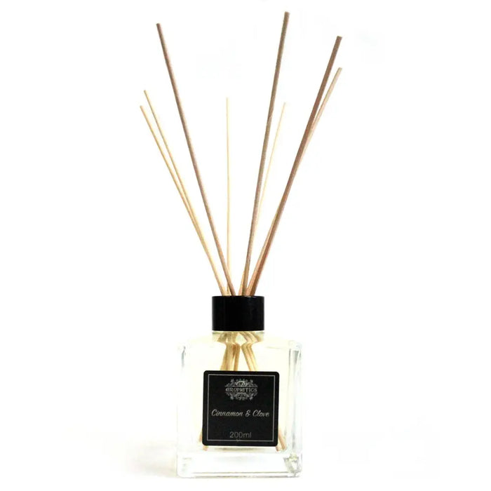Clear glass reed diffuser with black cap, light brown rattan sticks, 200ml cinnamon and clove essential oil scent