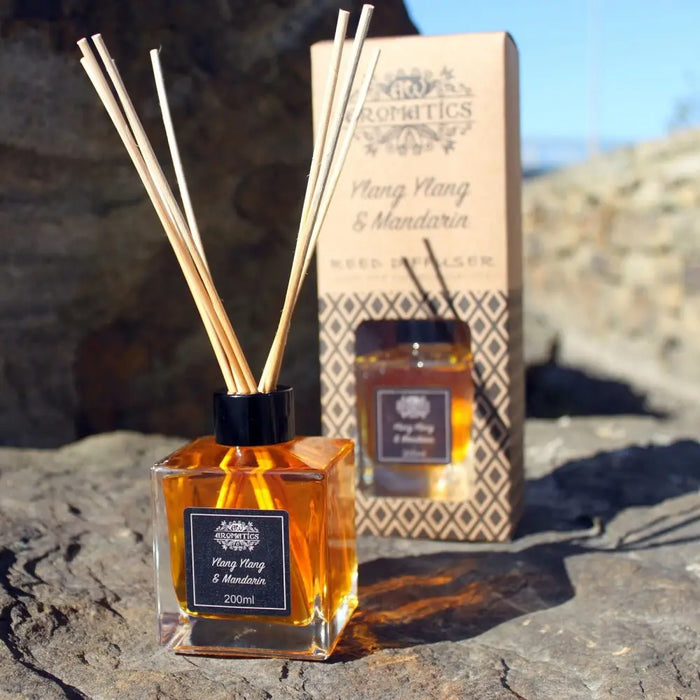 200ml lavender and fennel essential oil reed diffuser with amber liquid, black cap, and rattan sticks arranged around it