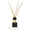 Clear glass reed diffuser with black cap and light wooden reeds featuring lemon verbena essential oil eco-mineral oil base