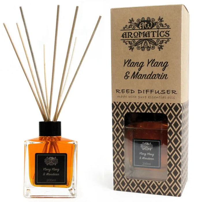 A clear glass 200ml reed diffuser with black cap and amber mandarin essential oil and ylang ylang liquid