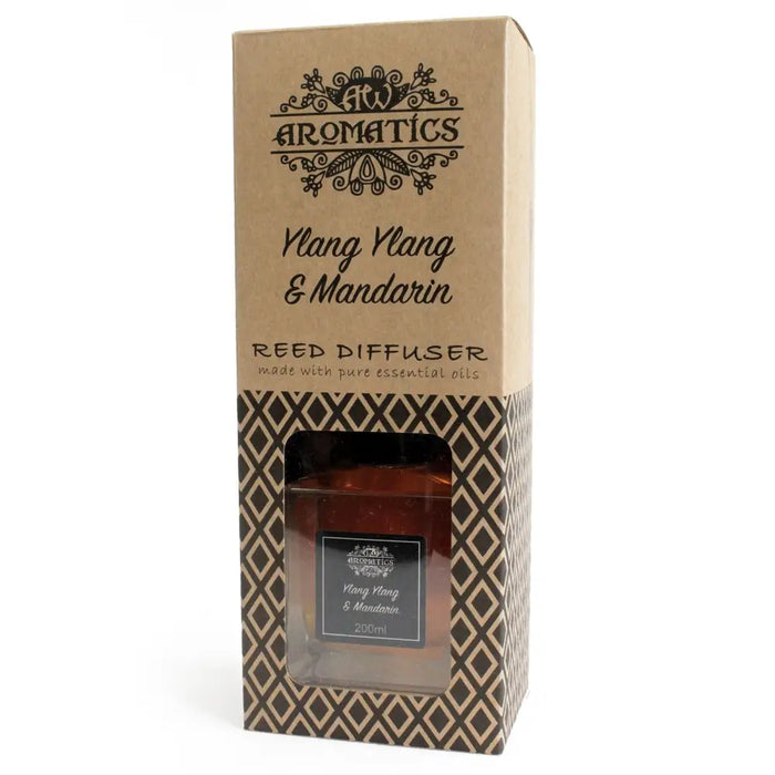 A brown glass reed diffuser bottle with mandarin essential oil and ylang ylang in a geometric patterned box by aromatics