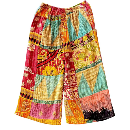 Vibrant kantha trousers with wide leg and green waistband featuring colorful patchwork and embroidered quilted fabric textures