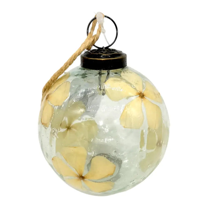 Clear glass 3 inch floral botanical bauble with dried pale yellow flowers sealed by black metal cap and twine loop