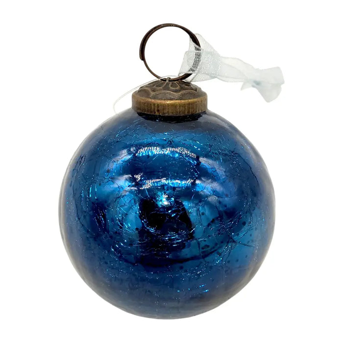 A 3 inch old navy blue glass christmas ornament with crackle effect glass and an antique brass cap