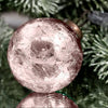 A 3 inch large rose quartz crackle glass christmas bauble with a metallic gold cap on a plain background