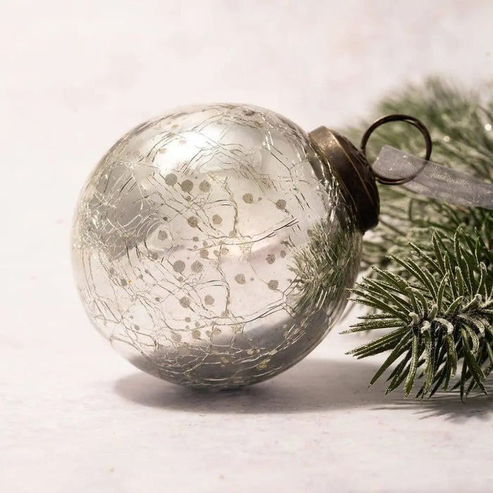A 3 inch large silver crackle glass christmas tree bauble ornament with a metallic gold rim and loop