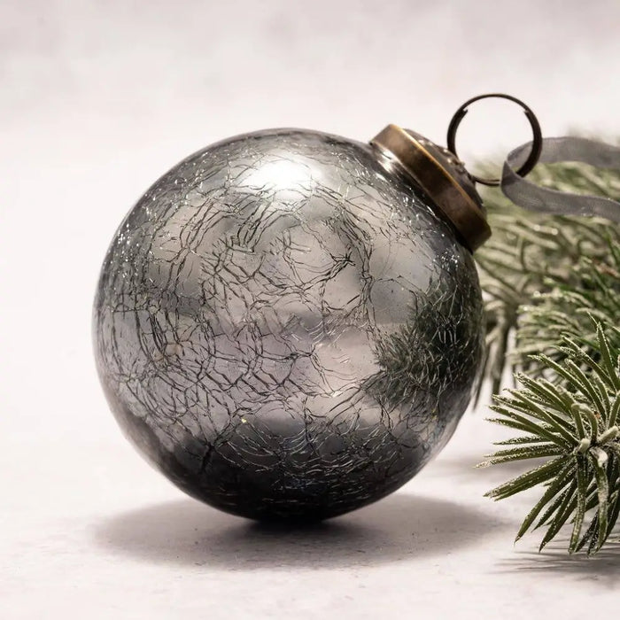 A 3 inch large slate crackle glass ball christmas ornament with a silver crackled finish and brass cap and loop