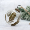 Clear glass 3 inch leaf botanical bauble with textured surface and embedded golden fern leaves and brass cap