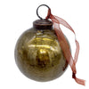 A 3 inch olive green crackle glass christmas bauble with a dark metal cap and rust colored ribbon tied at the top