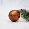 A 3 inch russet crackle glass christmas bauble with copper color and a vintage crackled finish with metallic cap