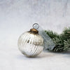 A 3 inch silver glass ribbed ball decoration with vertical ridges and a brass colored cap vintage style mercury glass ornament