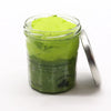 A vibrant lime green sugar body scrub with shea butter in a clear jar labeled classic mojito with a silver lid